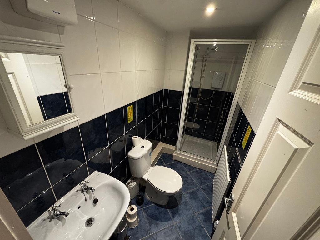 Neat tiled bathroom with a corner shower cubicl...