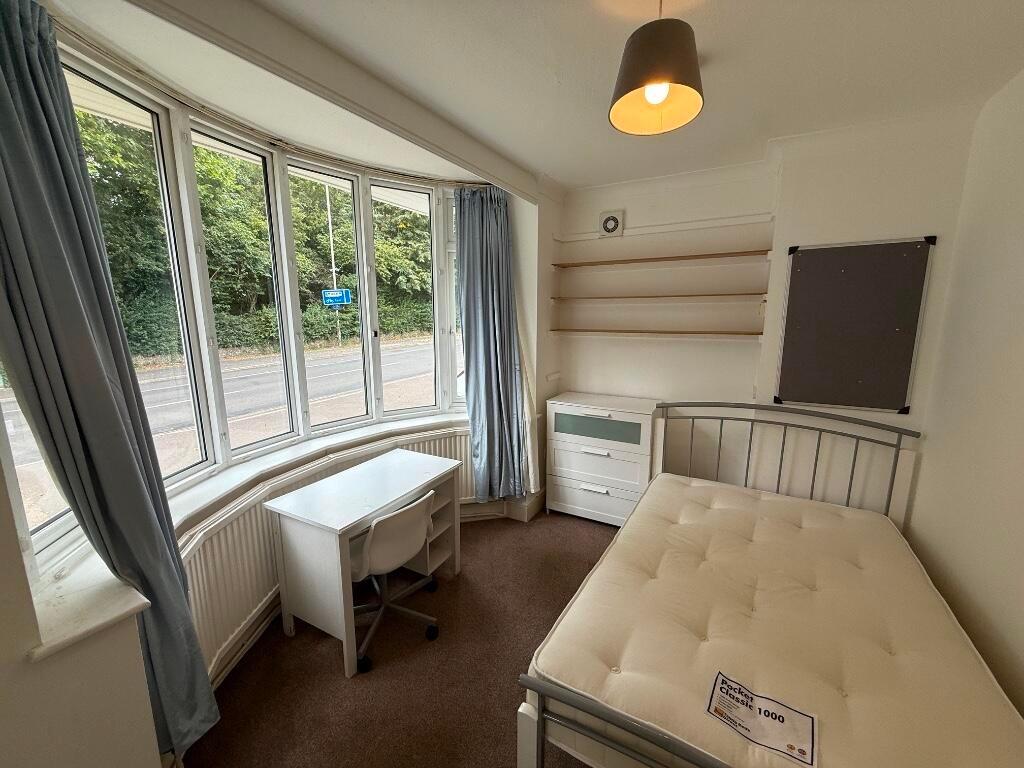 Bright furnished bedroom with a large bay windo...