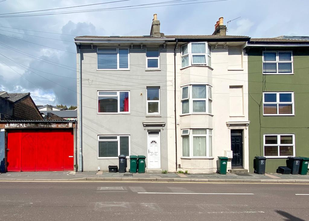 Row of terraced houses with bay windows and a b...