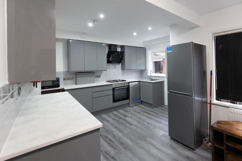 Modern and sleek kitchen with grey cabinetry, w...