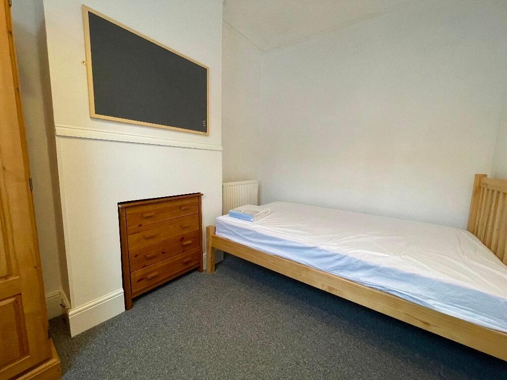 Bright, simply furnished single bedroom with a ...