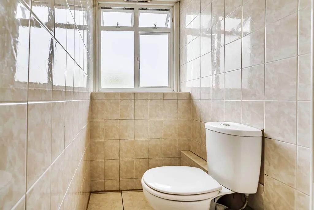Bright tiled WC with frosted window...