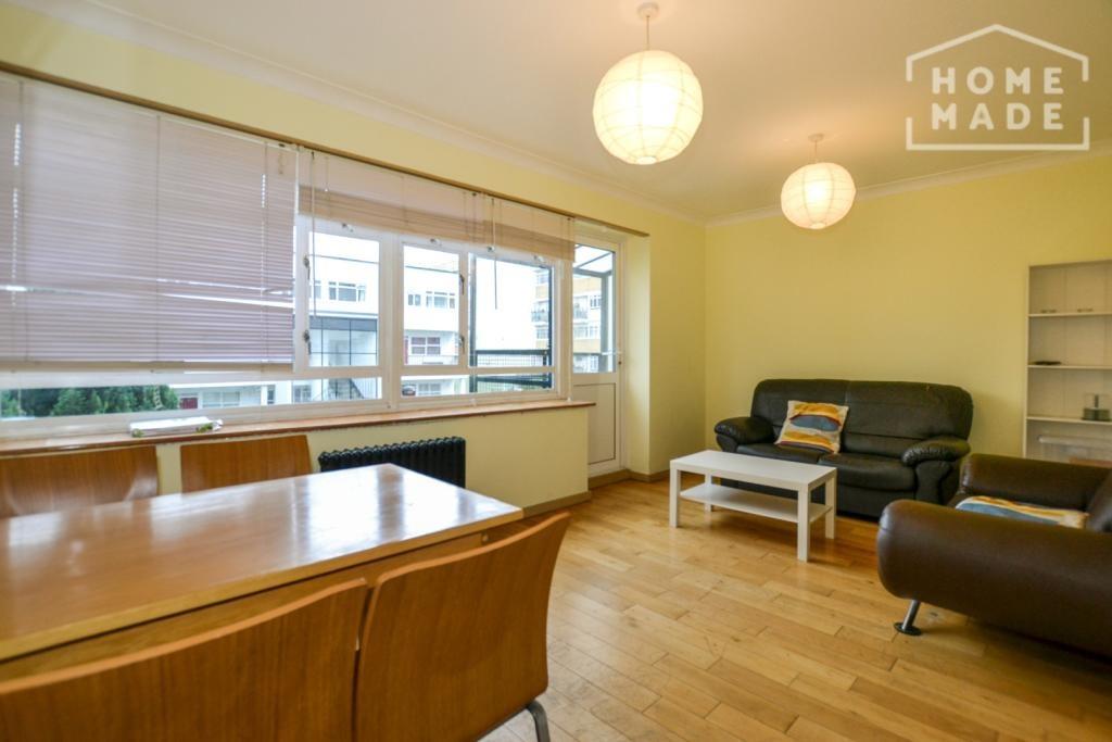 Bright furnished living room with dining area...