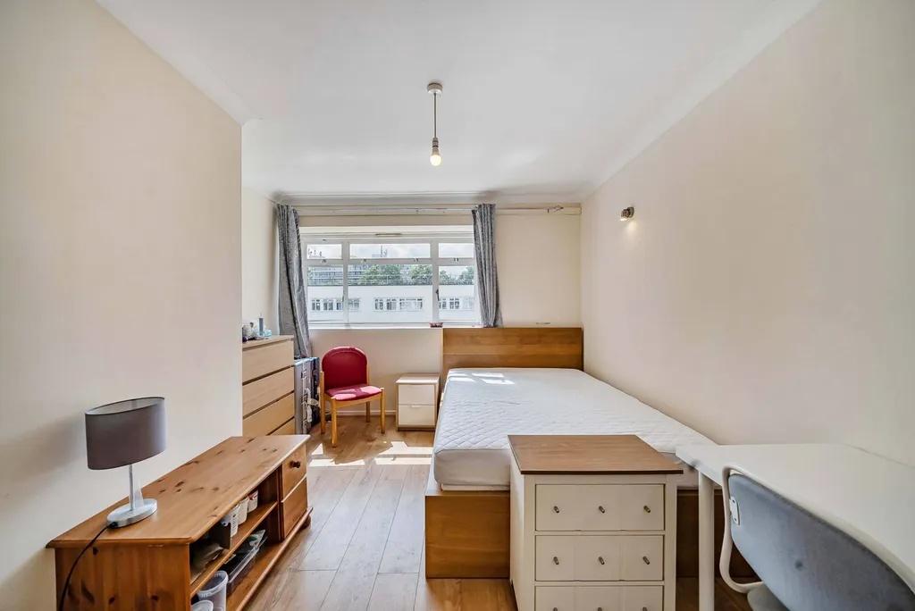 Bright furnished bedroom with large window...