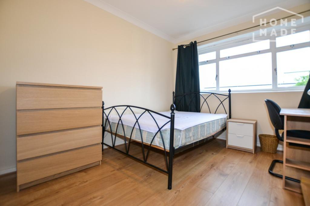 Bright double bedroom with desk and storage...