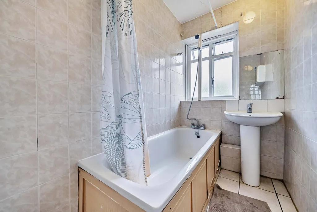 Bright bathroom with shower-over-bath...