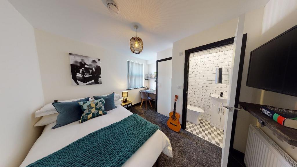 A cozy and well-maintained bedroom with a neatl...