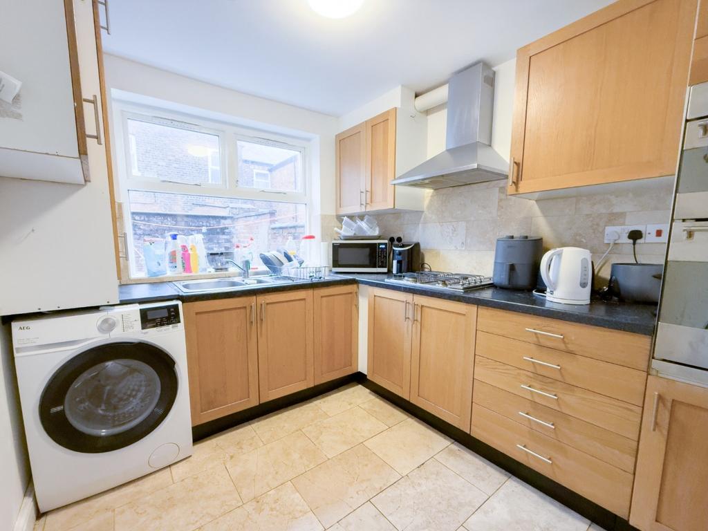 Bright fitted kitchen with appliances and stora...
