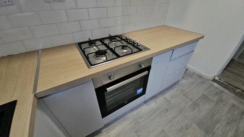Modern fitted kitchen with hob and oven...