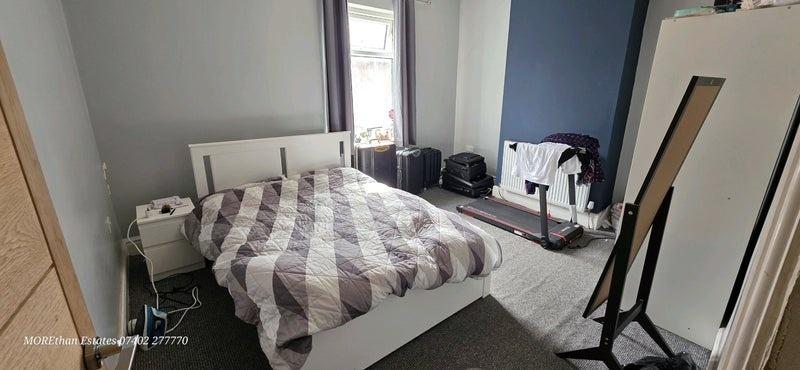 Bright bedroom with double bed and storage...