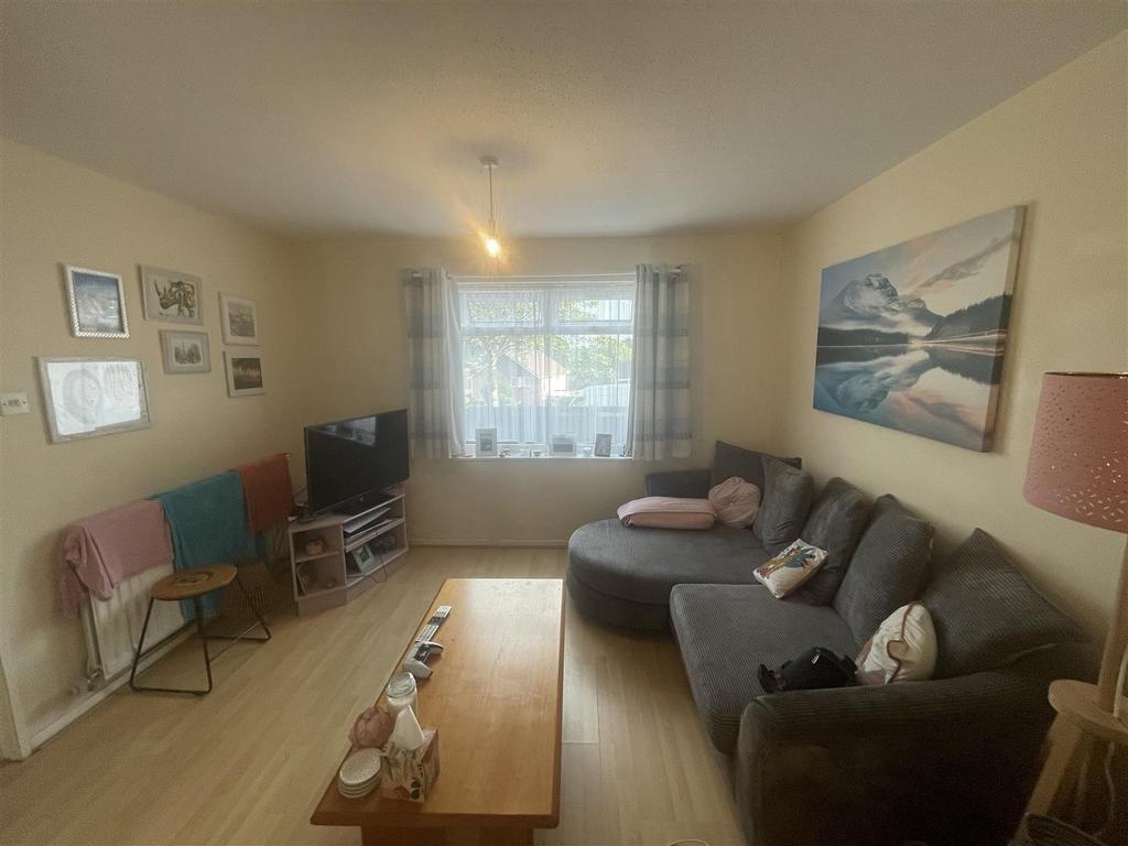 Bright, cosy lounge with sofa and coffee table...