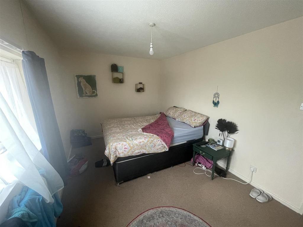 Bright bedroom with double bed and storage...