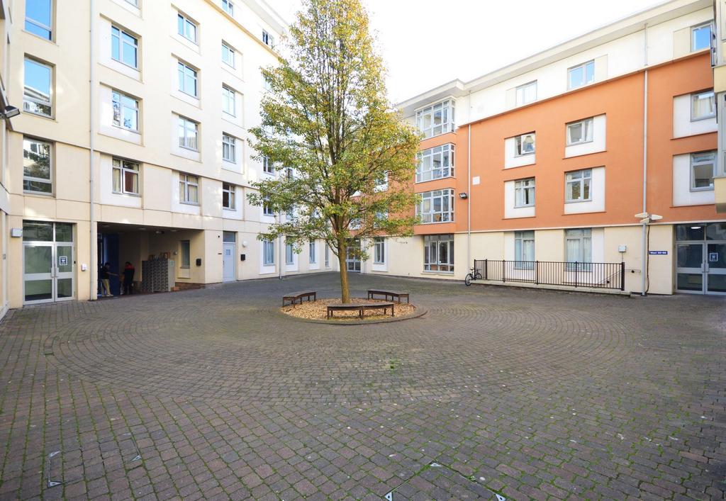 Bright central courtyard with seating and tree...