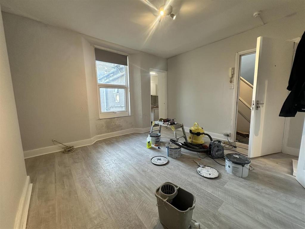 Bright lounge with bay window and neutral decor...