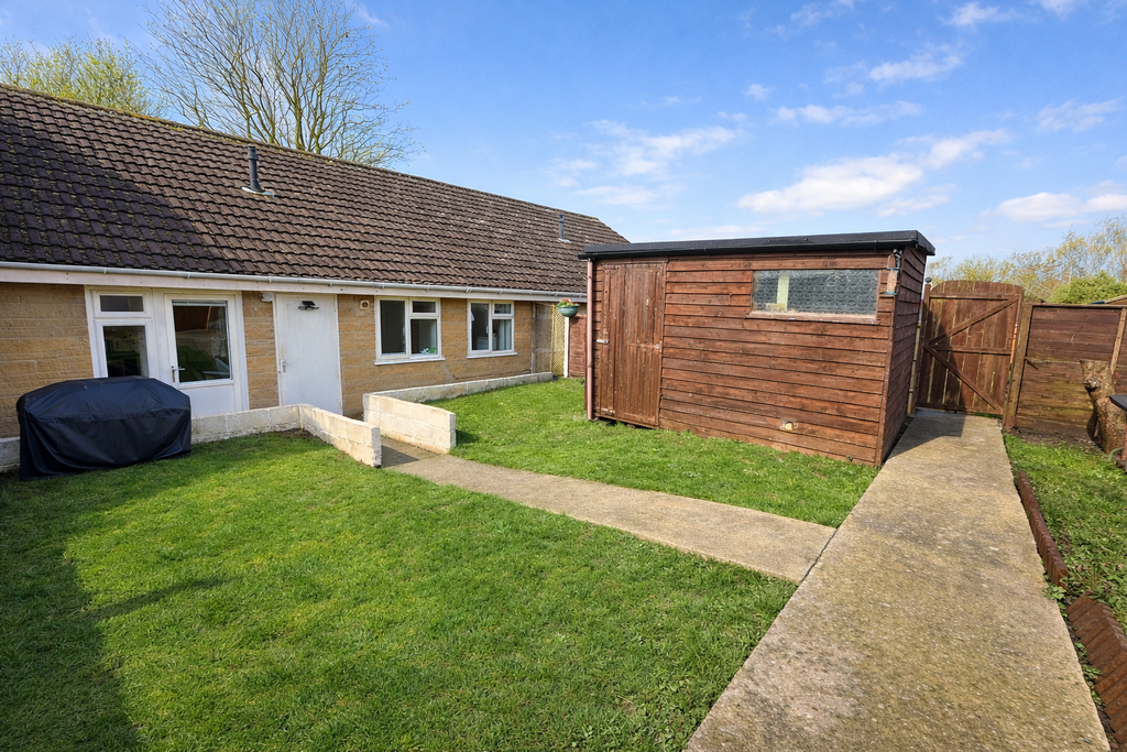 Sunny garden with timber shed