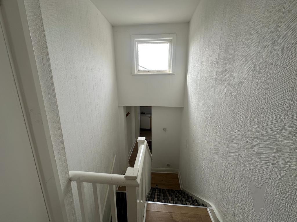 Bright painted stairwell with natural window li...
