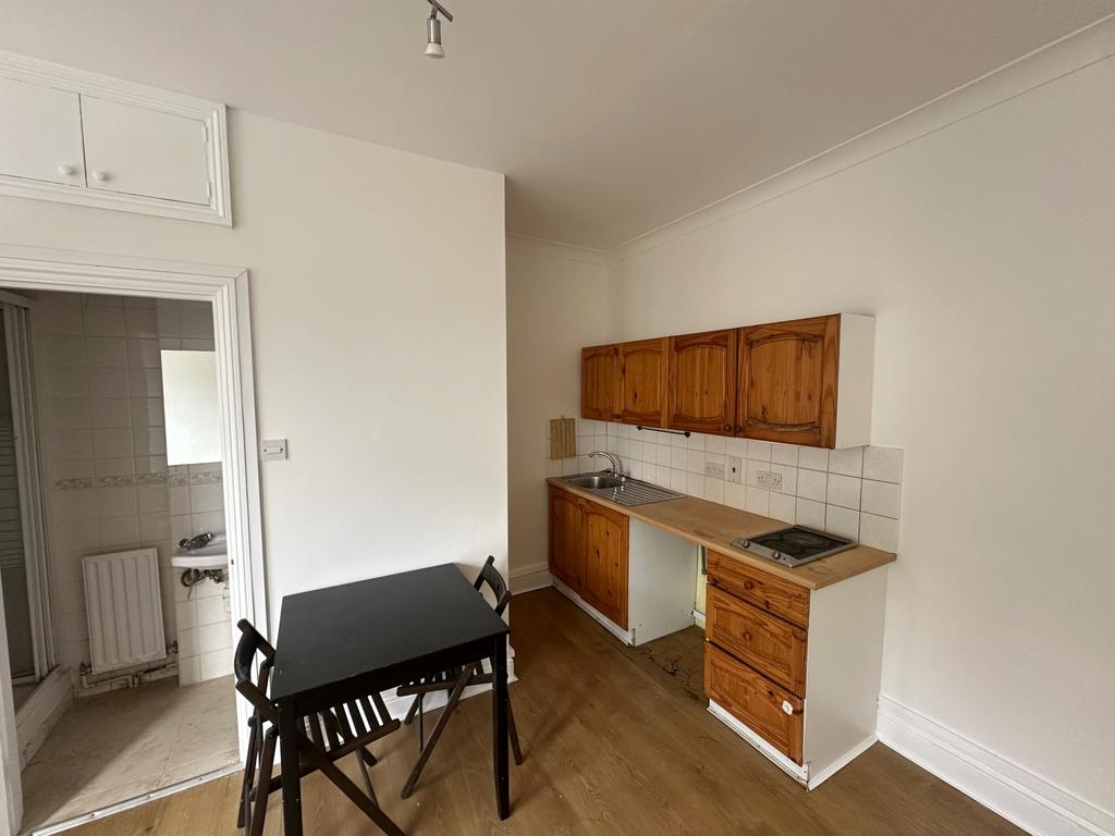 Compact kitchen with dining table and natural t...