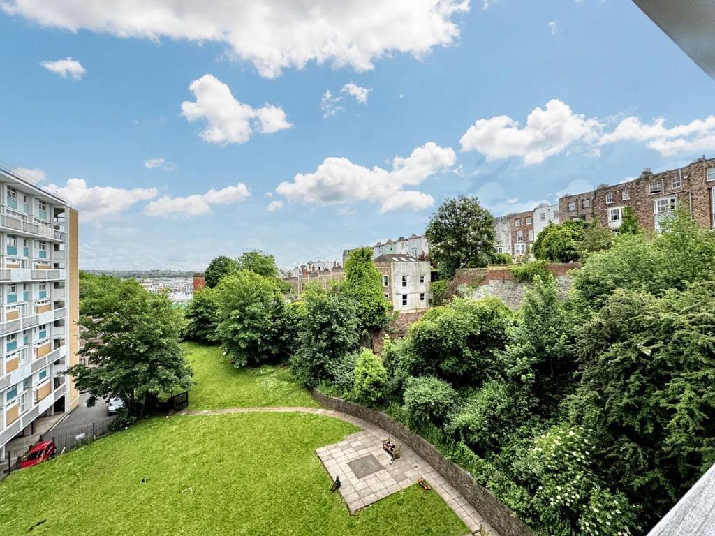 Sunny communal green space with river view...