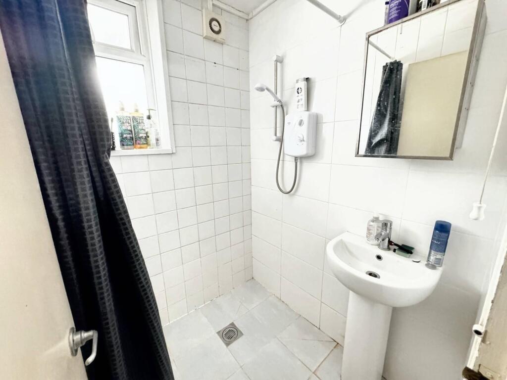 Bright simple bathroom with walk-in shower...