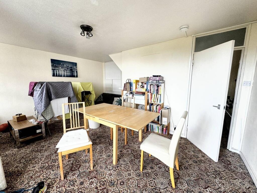 Bright shared lounge with dining table and seat...
