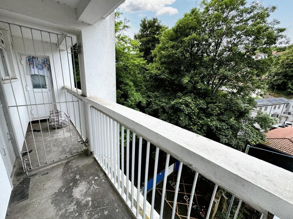 Balcony with leafy treetop views and outdoor sp...
