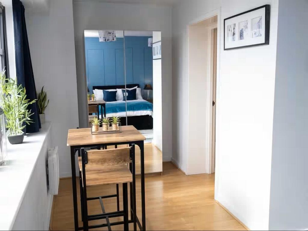 Bright, modern bedroom with a mirrored wardrobe...