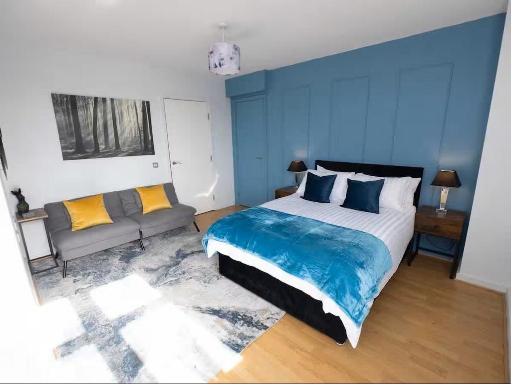 Bright, modern master bedroom with a comfortabl...