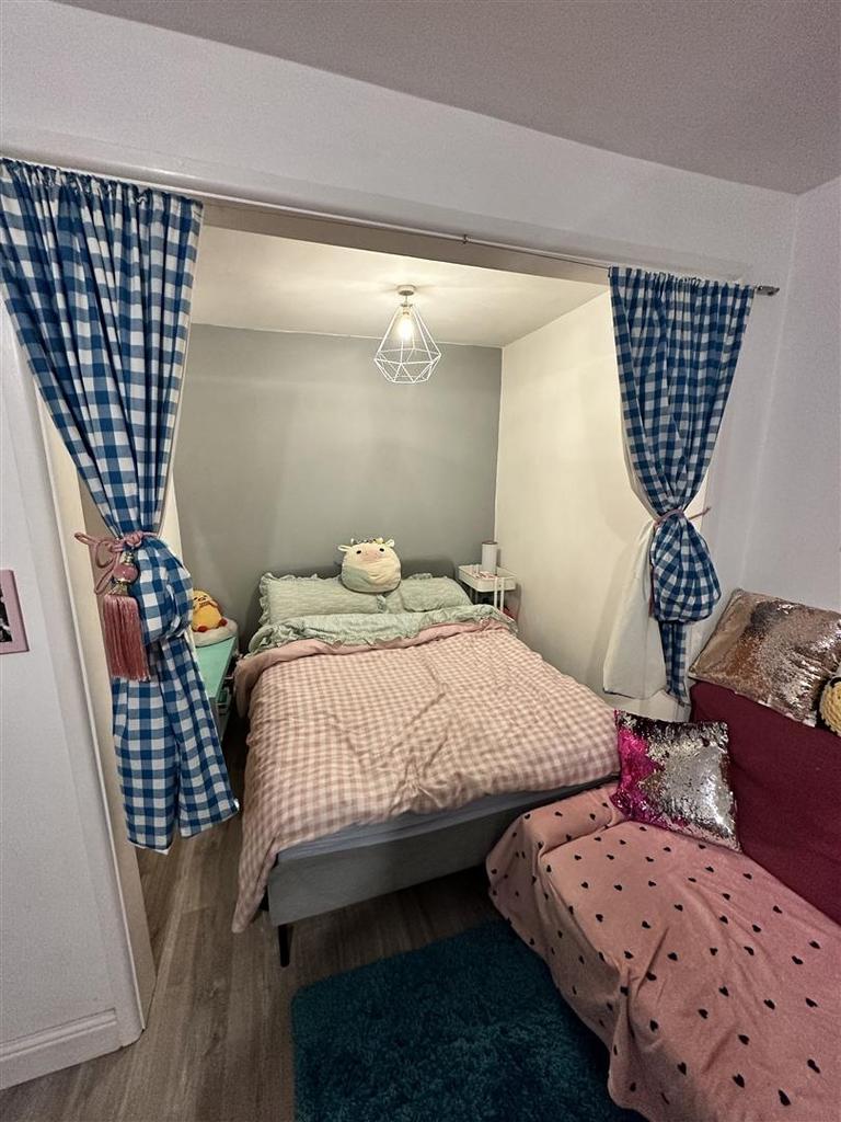Cozy double bed alcove with pretty curtains...