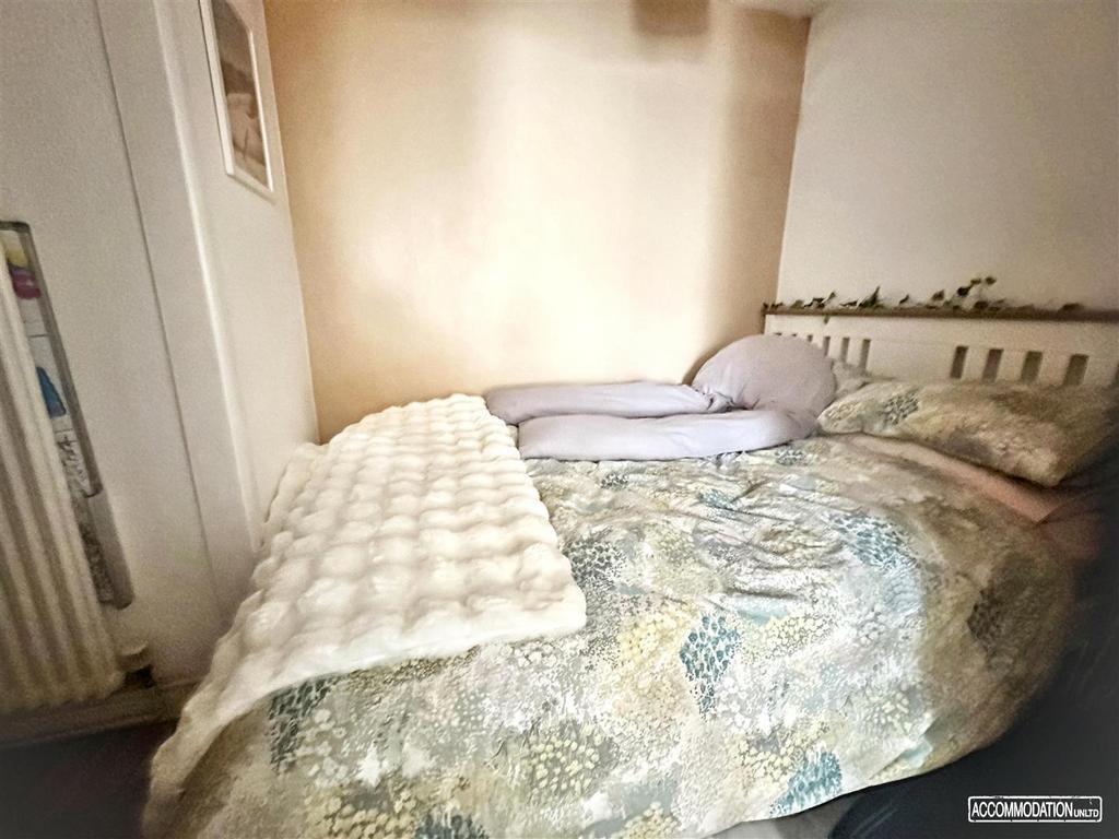 Bright cozy double room with patterned bedding...