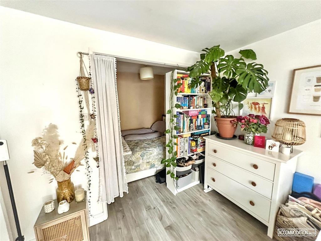 Bright, cosy bedroom with storage and plants...