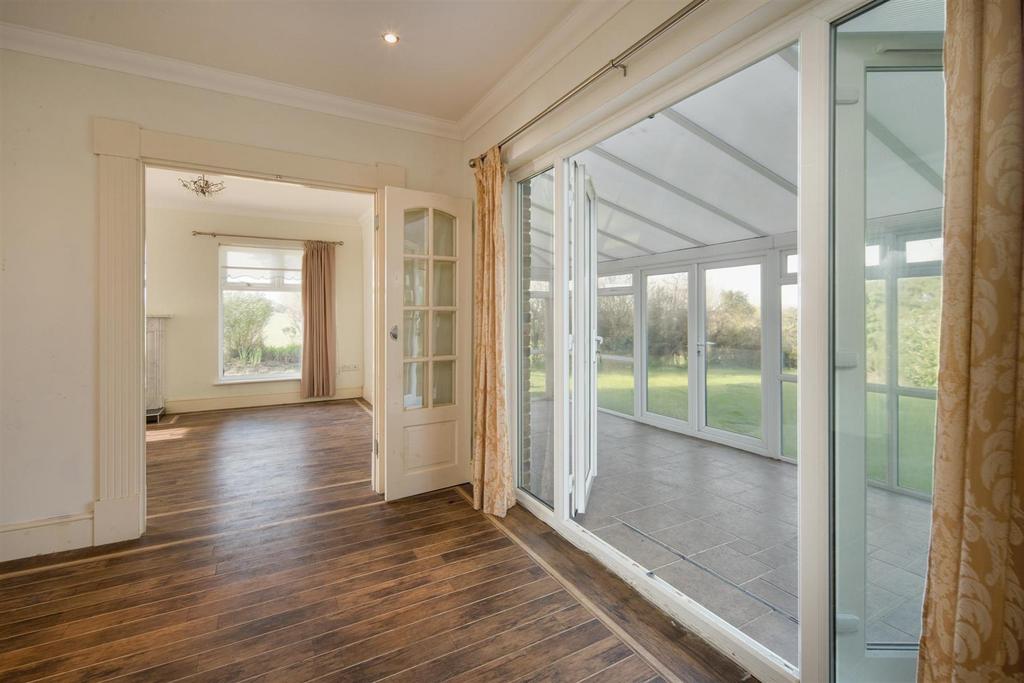Dining Room With View Into Living Room & Conservat