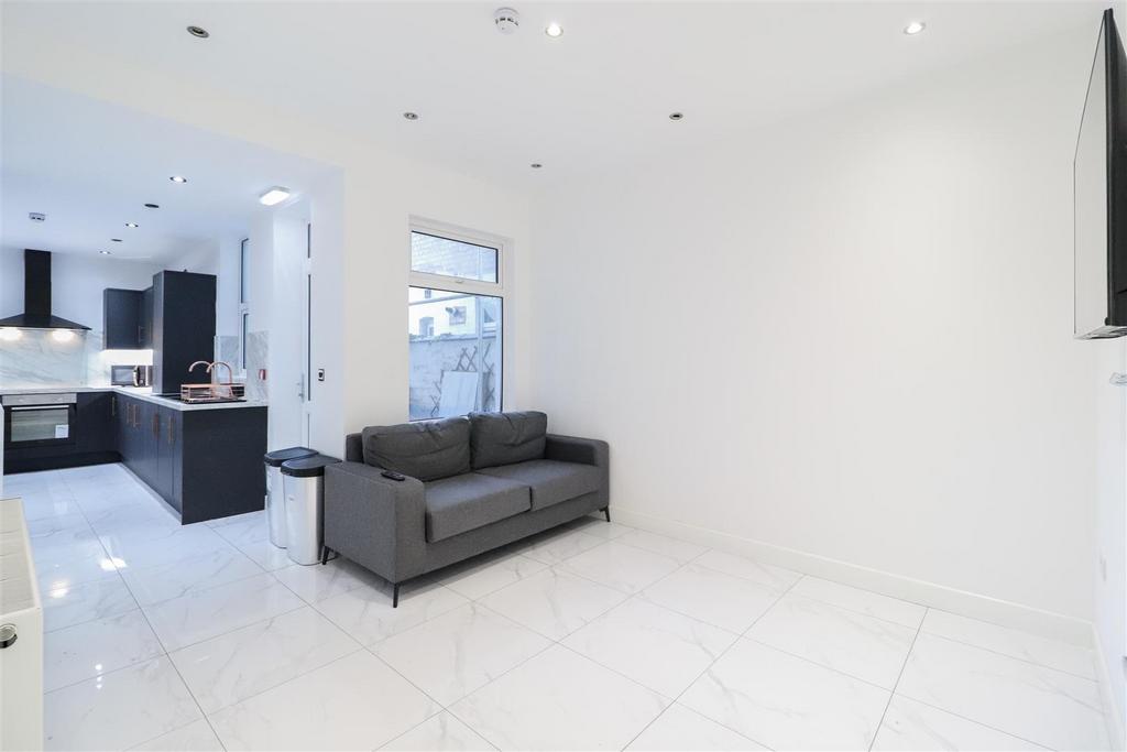 Bright, modern open-plan living area with gloss...