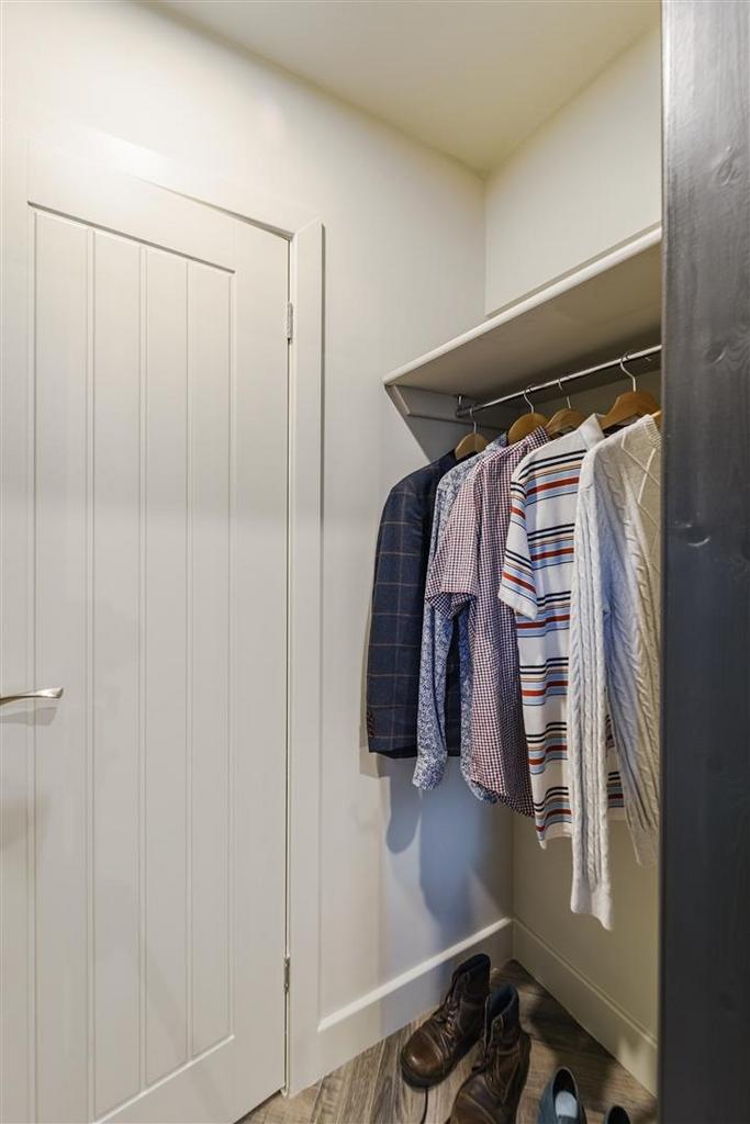 Neat fitted closet with hanging space and shelv...