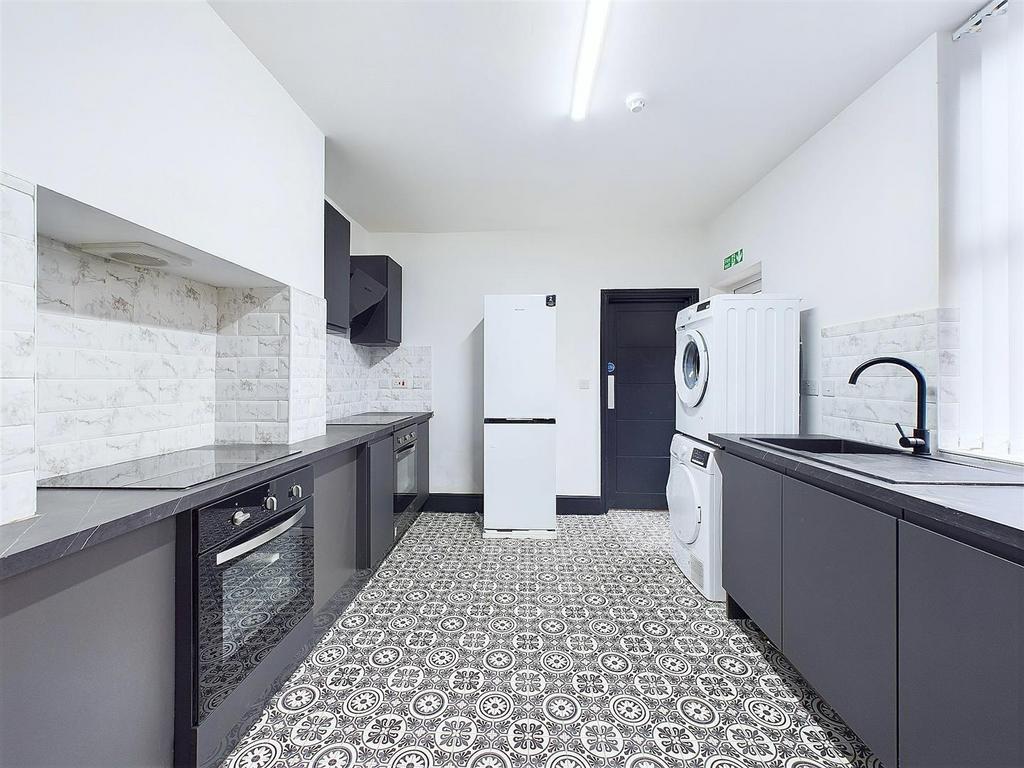 Bright modern kitchen with patterned tiles...