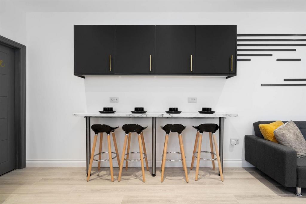Contemporary kitchenette with a breakfast bar, ...