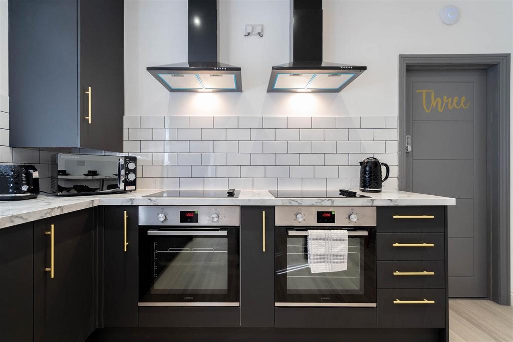 Modern fitted kitchen with twin ovens, matching...