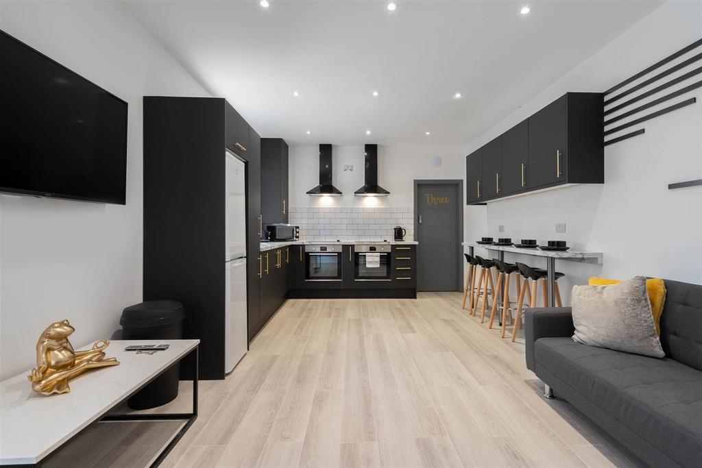 Contemporary open-plan living space with a slee...