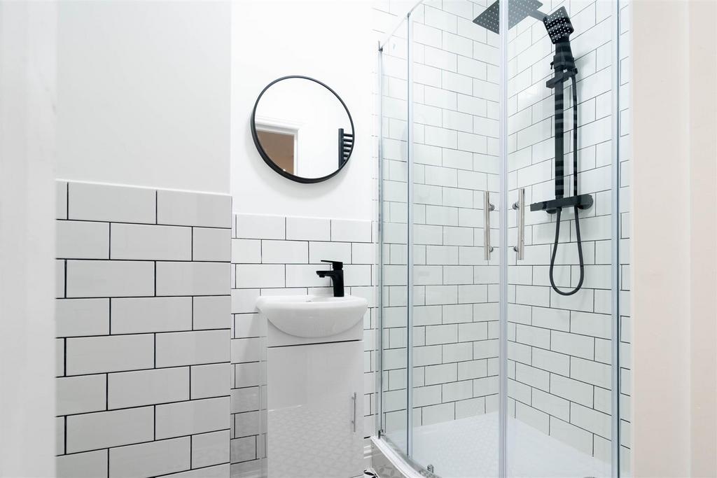 Bright modern bathroom with white subway tiles,...