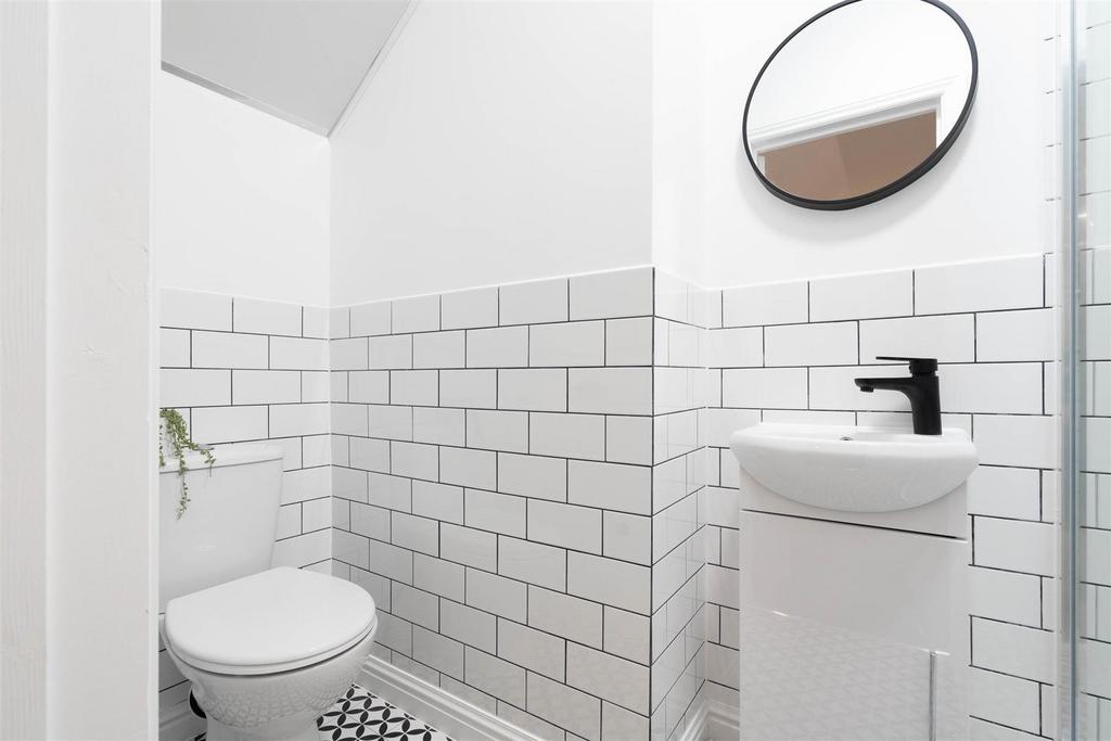 Bright, modern WC with clean white subway tiles...