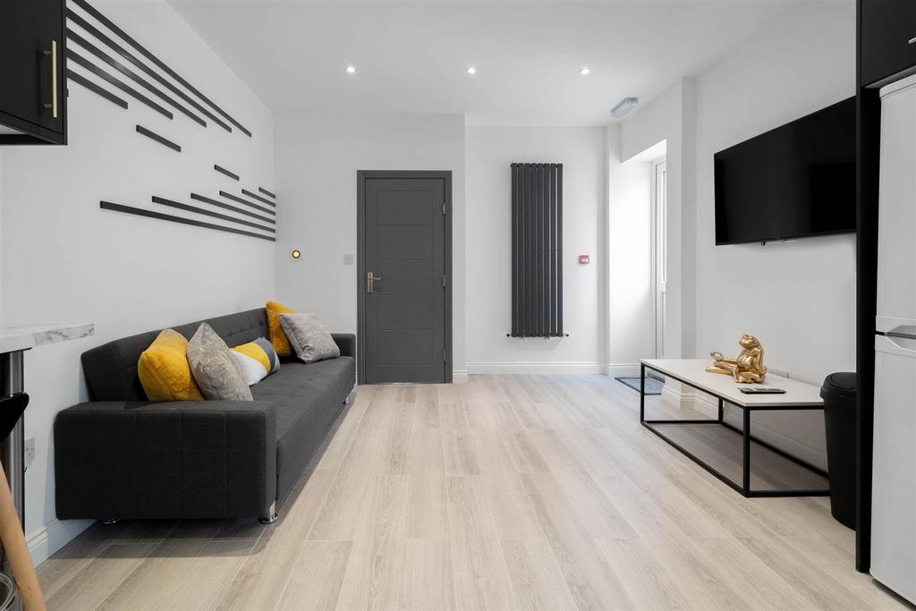 Bright, modern living room with light wood floo...