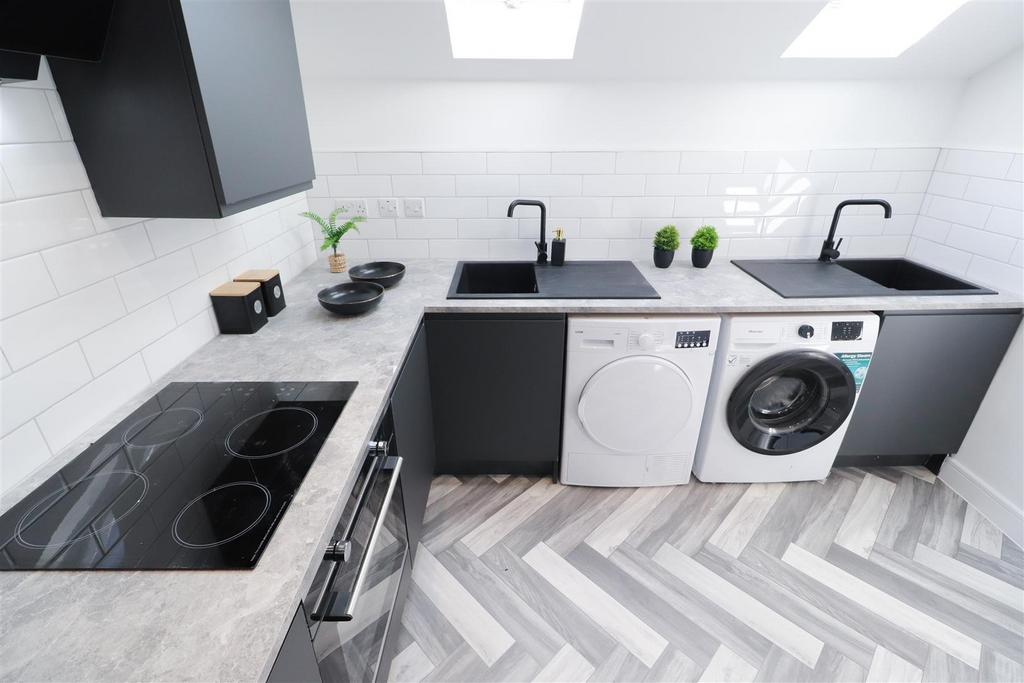 Modern fitted kitchen with washer and dryer...