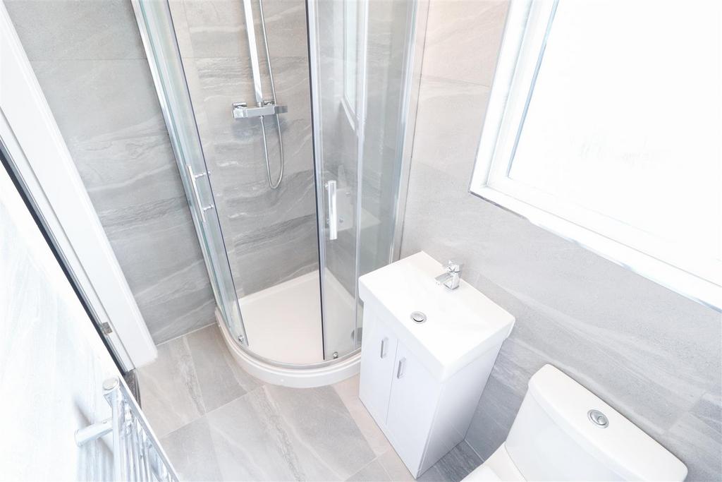 Modern bathroom with bright shower enclosure...