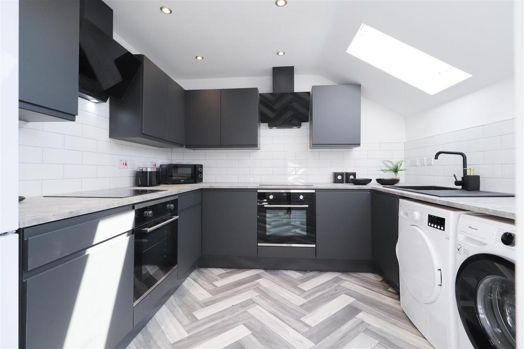 Modern fitted kitchen with sleek appliances...
