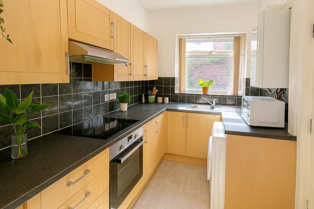 Bright and modern kitchen featuring wooden cabi...