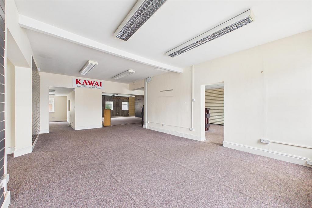 Bright, open communal workspace with carpeted f...