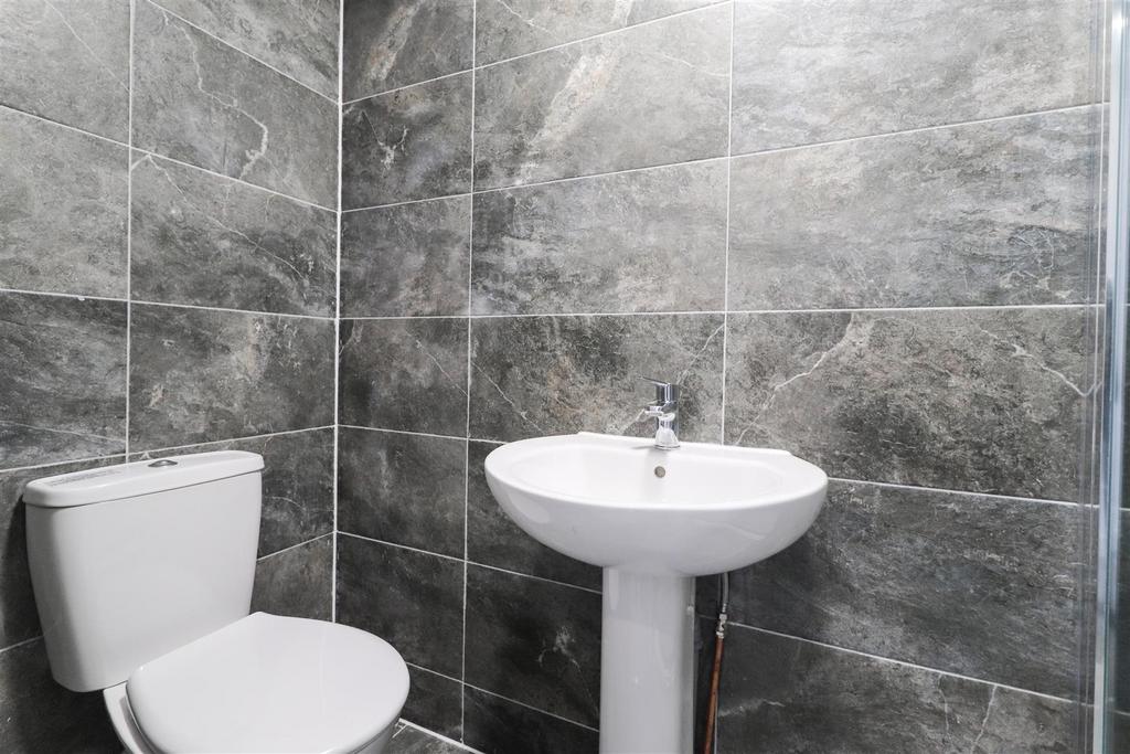 Modern bathroom with stylish grey wall tiles, p...