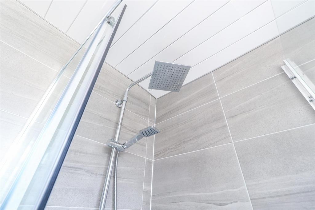Modern tiled shower with rainfall head...