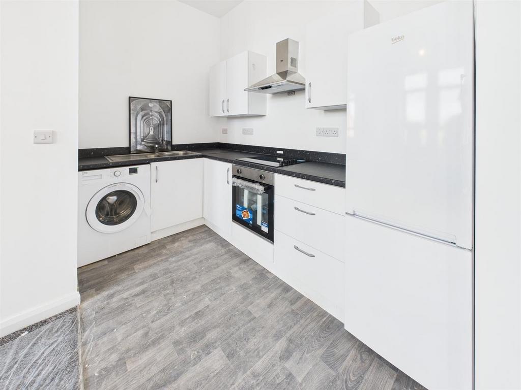 Modern white kitchen with appliances and sleekw...