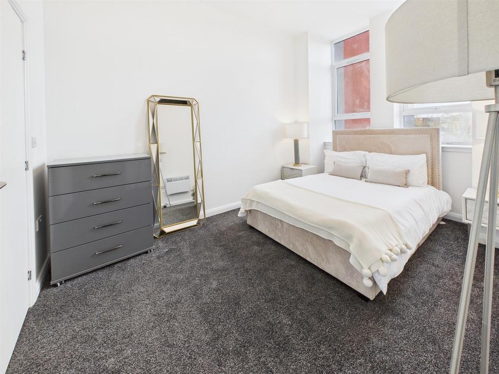Bright, modern double bedroom with neutral deco...