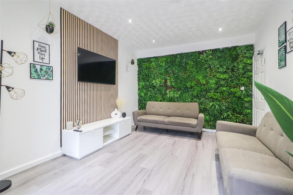 Bright, modern living room with light wood floo...